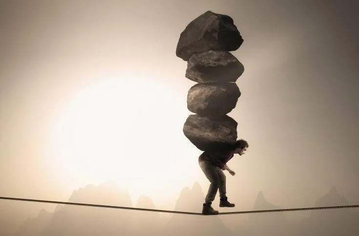Man carrying many rocks