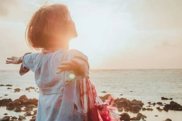 woman open arm embracing life