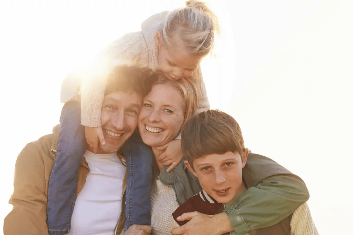 A family with kids smiling because they heeded the advice of the Raise Foundation’s Executive Director, Eldon Baber, and took measures to protect their children with My Family ID.