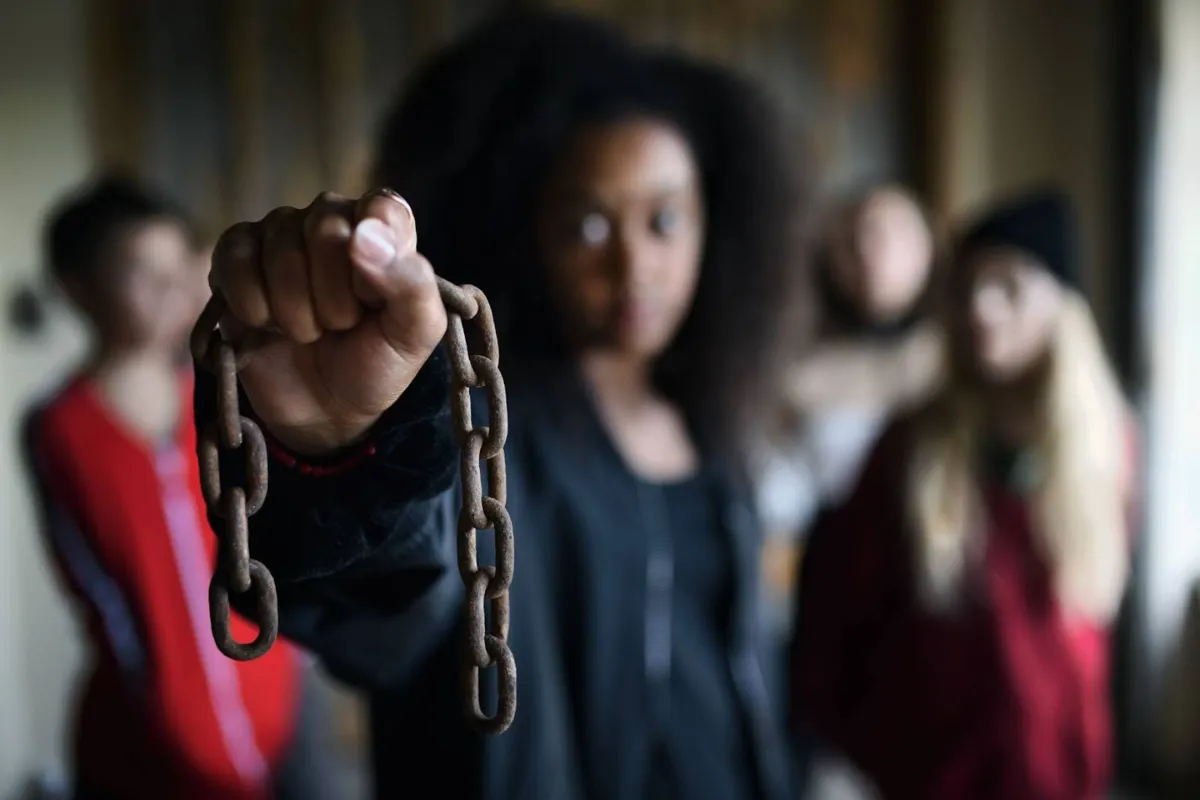 An image of women who have been trafficked holding a broken chain, a fitting metaphor for the mission that defines the Alliance to End Human Trafficking (AEHT).