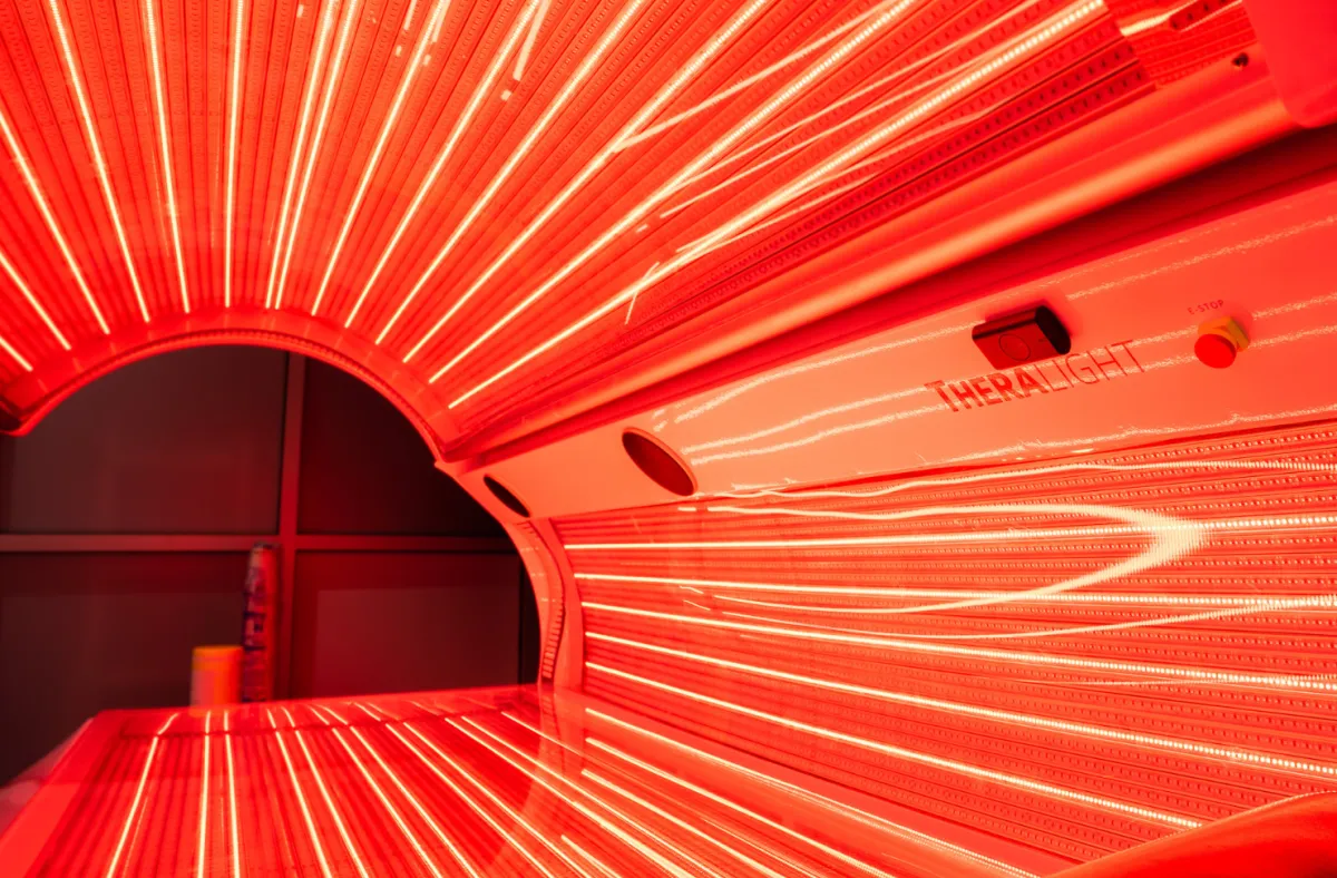 A red light therapy bed with the lights on