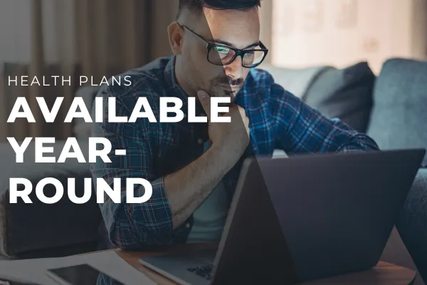 Person looking slightly stressed or uncertain while reviewing insurance documents, with a hopeful tone