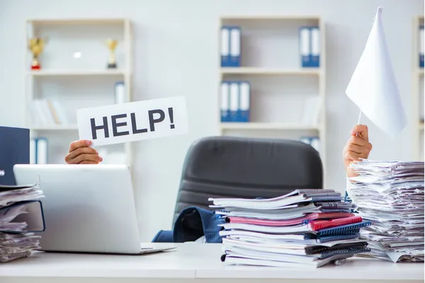 man holding laptop and sign that says help