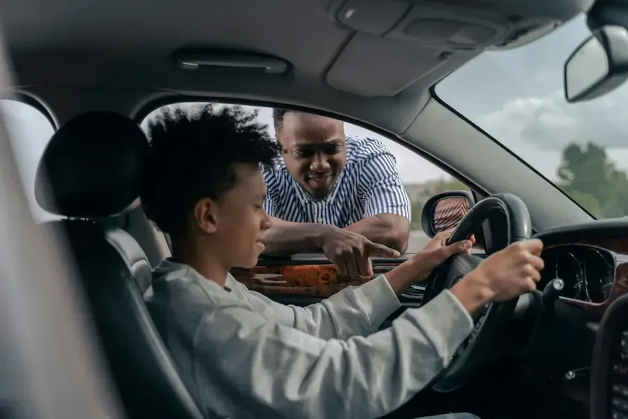Teen driver practicing behind the wheel with adult supervision during a permit lesson at Adventure Driving School in New Jersey.