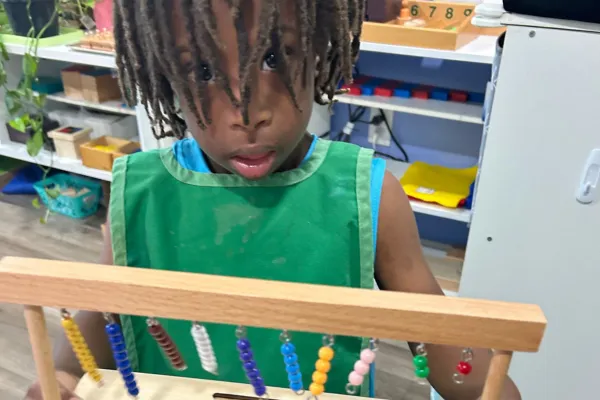 Child holding short bead stairs