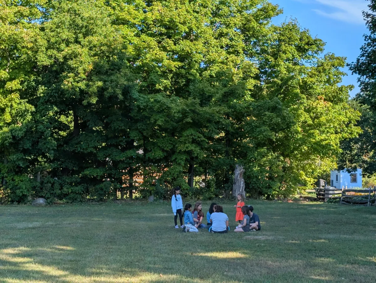 Learners in a circle outside