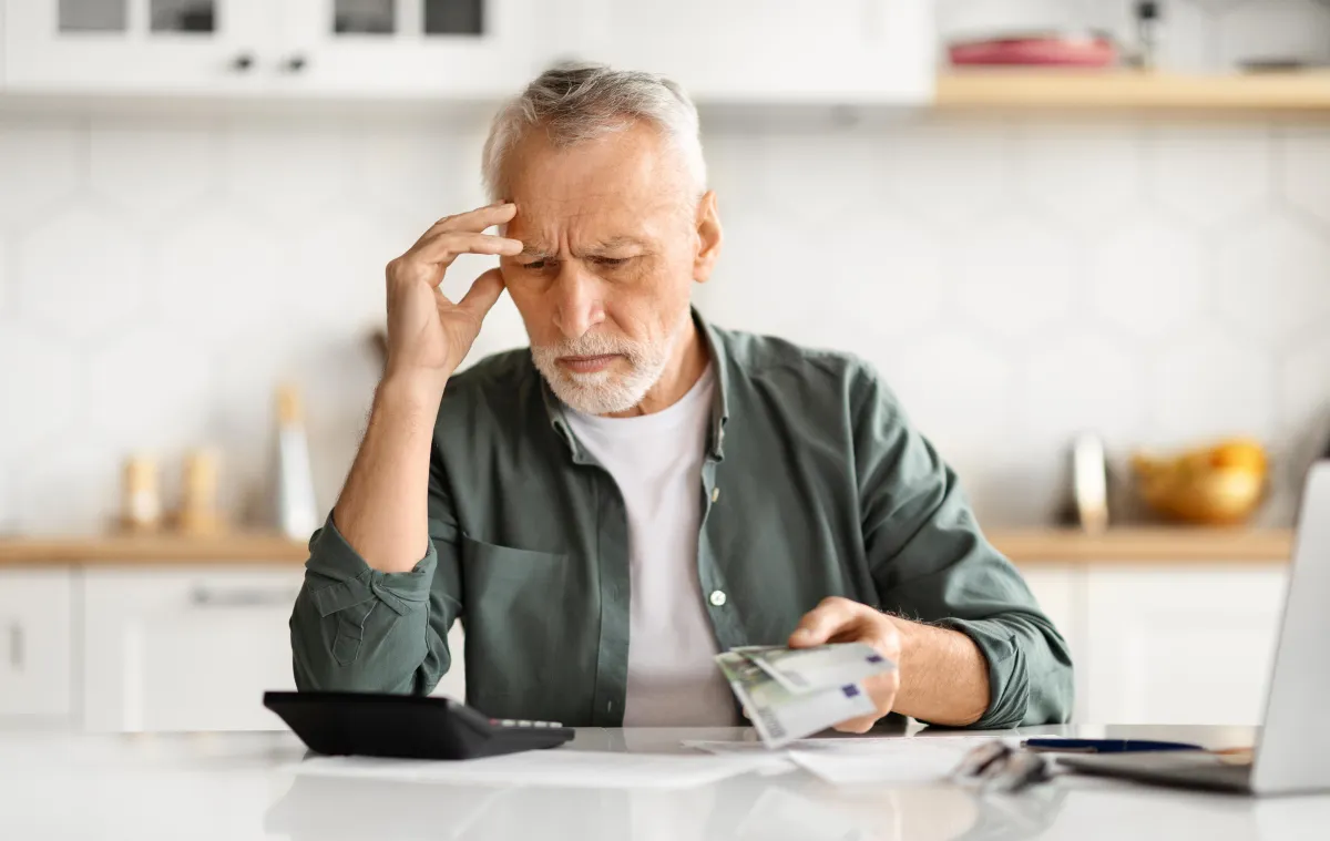 Anxious man counting money