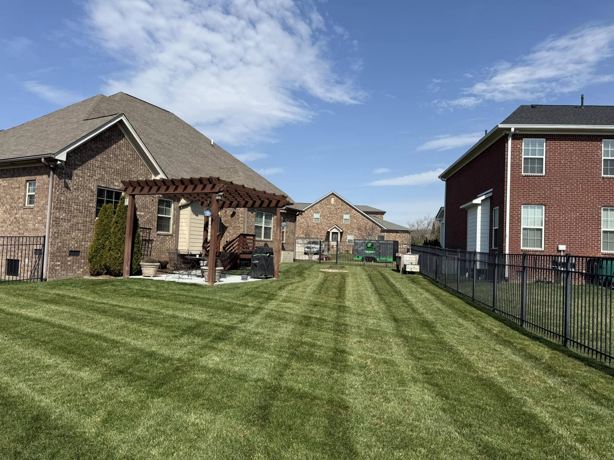 Professional backyard mowing service Spring Hill property - Brewer truck and equipment