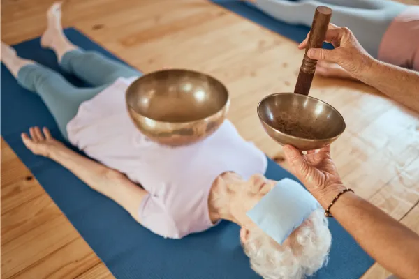 Article exploring the benefits of sound healing and music therapy for senior citizens, detailing how these practices support physical, emotional, and cognitive health, with a focus on stress reduction, pain management, and improved quality of life.