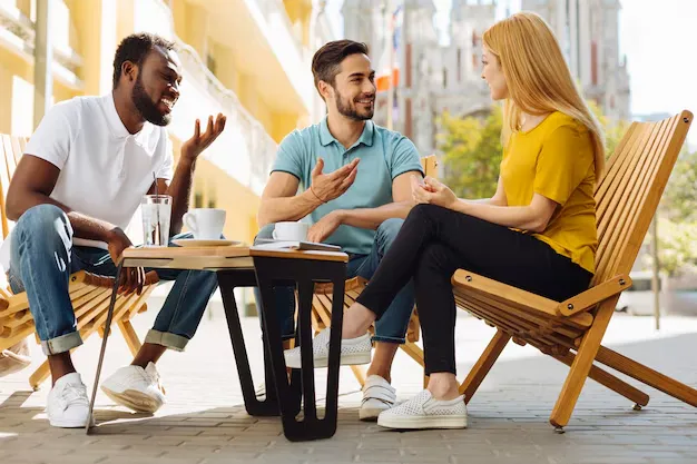 Young people sitting around having conversation