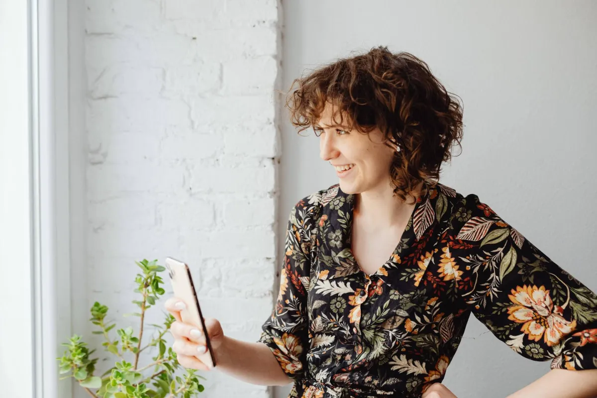 Woman smiling at her authentic reflection