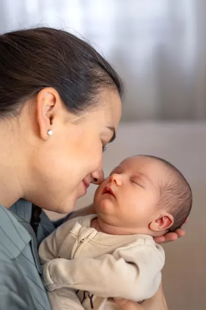 Mom kissing baby