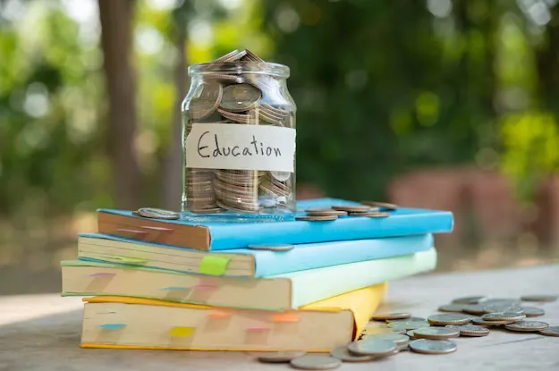 Education savings jar over books
