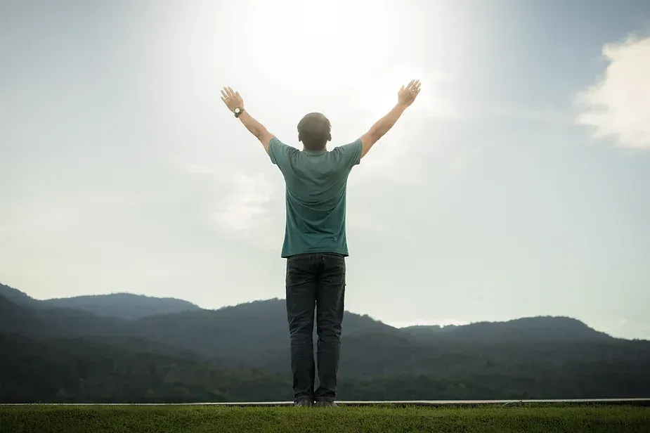 Man worshiping with uplifted arms