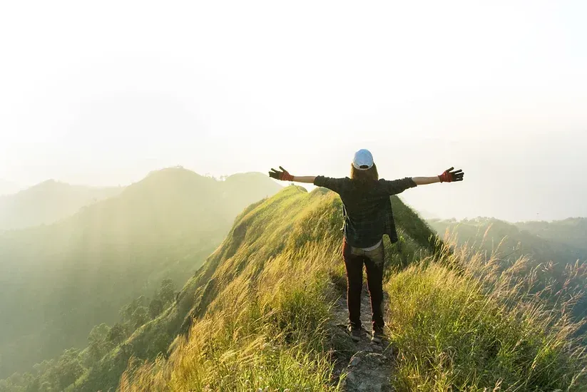 Man with arms lifted to the heavens