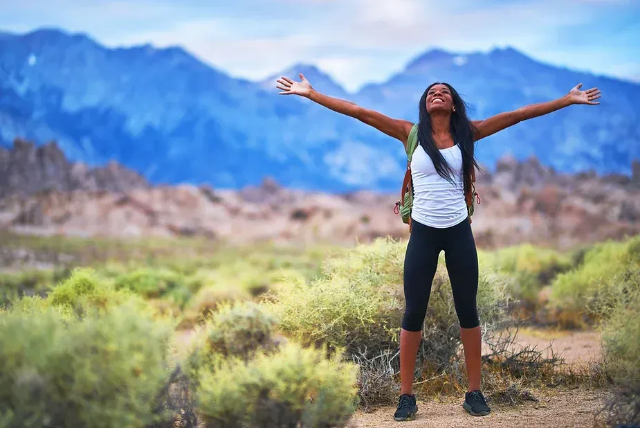 Woman hiker rejoicing