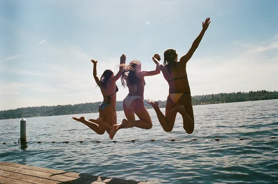 Women jumping into the water