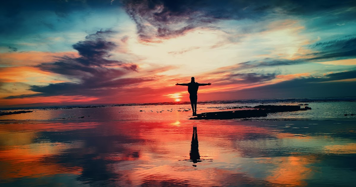 person walking along the beach