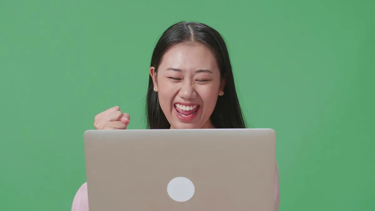 Confident minority woman wellness professional smiling in a bright studio while using a tablet to automate her business tasks