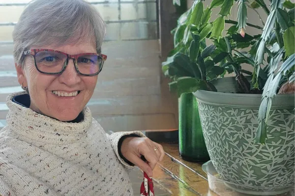 Claudette wearing long sleeves, smiling, showing her natural healing journey with gut-brain-skin connection.