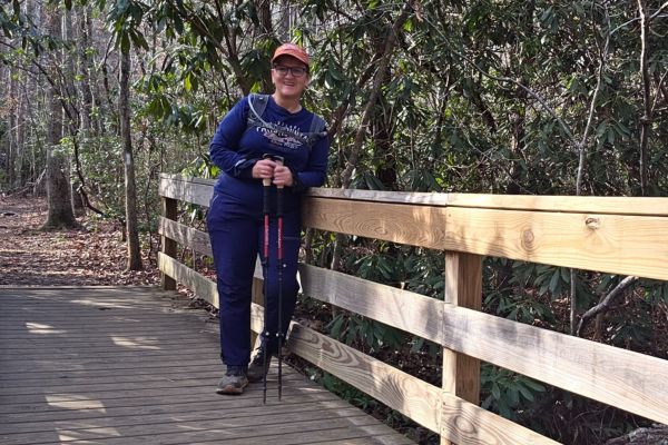 Woman walking outdoors in nature, rebuilding calm and strength naturally during a season that feels heavier