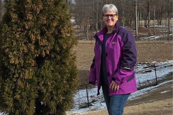 Woman standing outdoors in winter light, symbolizing quiet strength, resilience, and healing after loss.