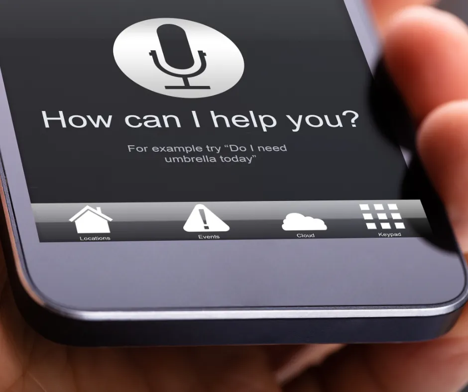 Photo of the voice recognition screen of a mobile phone, asking the user "How can I help you?"