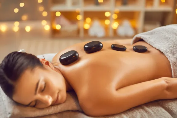 Hot stone massage Bellevue with nature-inspired decor offers deep relaxation and stress relief in a serene Crossroads setting.