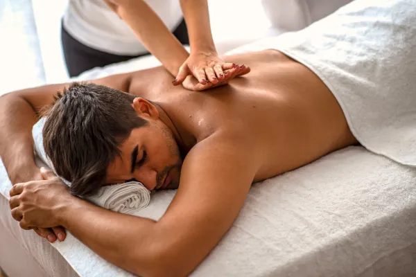 Softly lit massage room in Bellevue with calming essential oils offers Swedish massage stress relief for ultimate relaxation.
