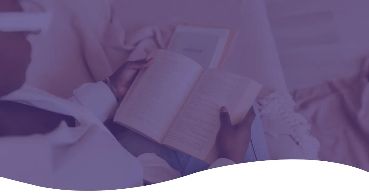 An open book in a reader's lap