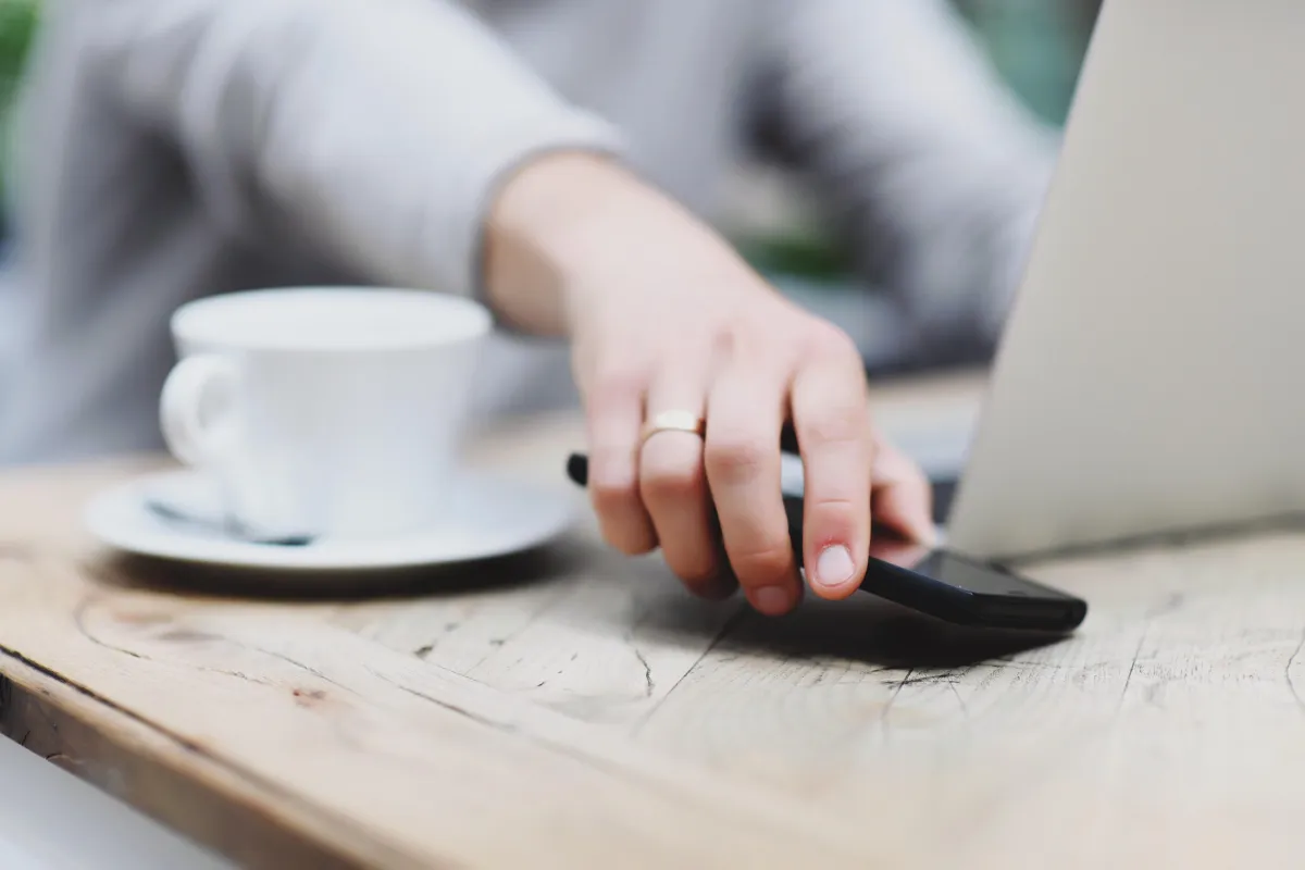 Female hand reaching for a phone.