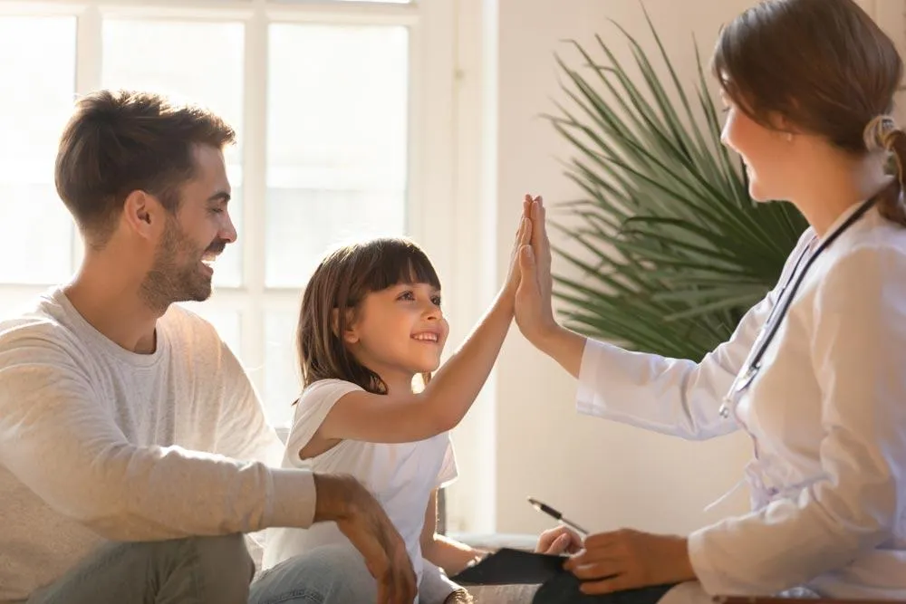 orthopedic physician with patients after securing practice loan