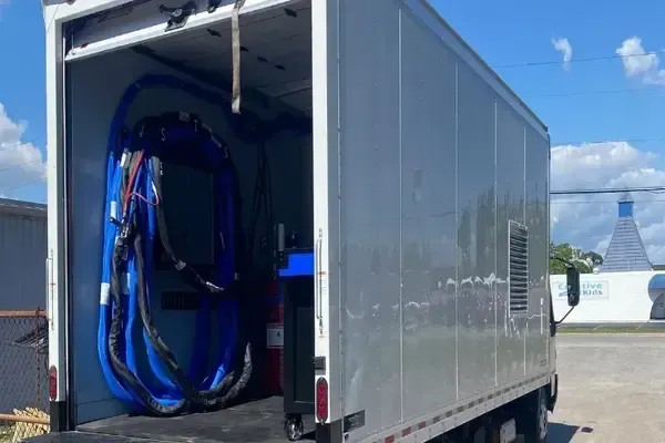 Custom spray foam insulation rig with trailer and mounted equipment