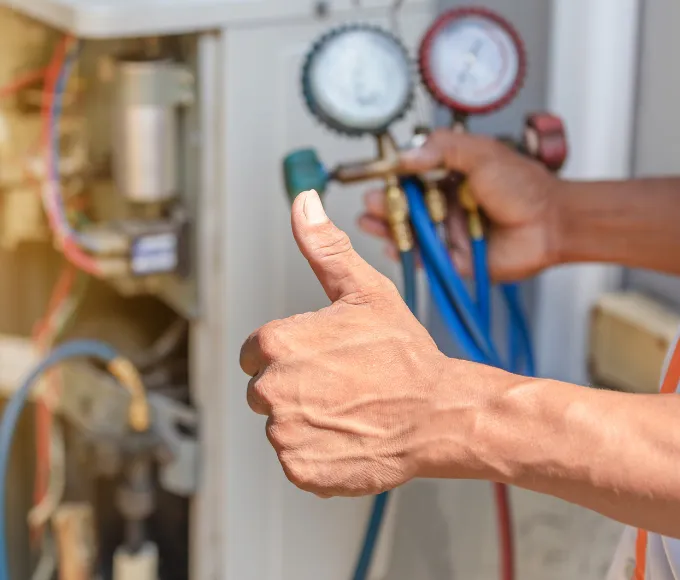 hvac tech in mesquite doing routine hvac maintenance on a home