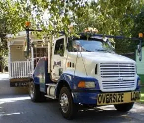 Bush Mobile Home Moving truck pulling out