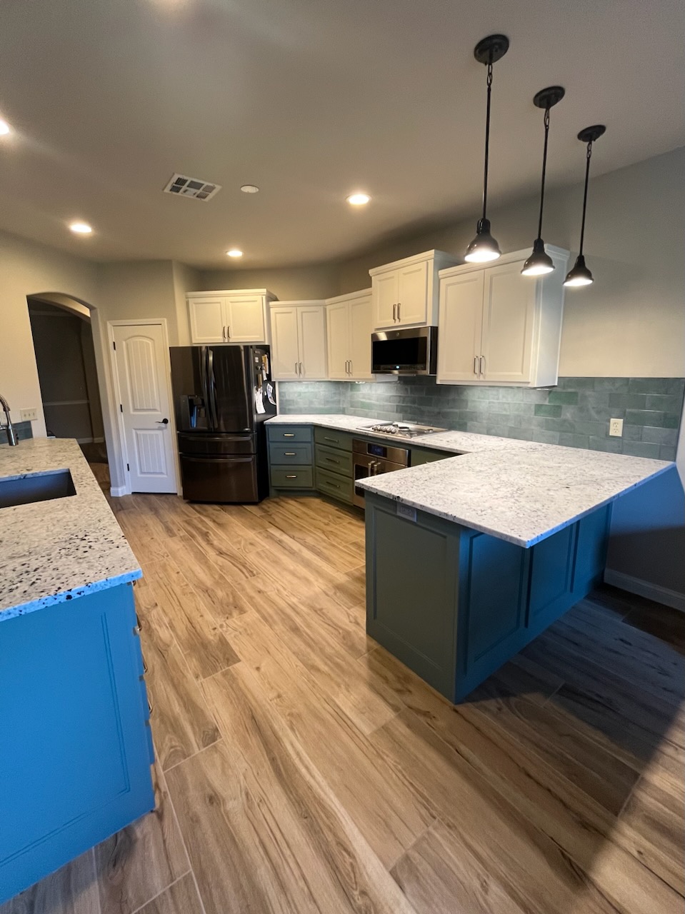 Bright kitchen remodel featuring white shaker cabinets, apron-front farmhouse sink, and marble countertops
