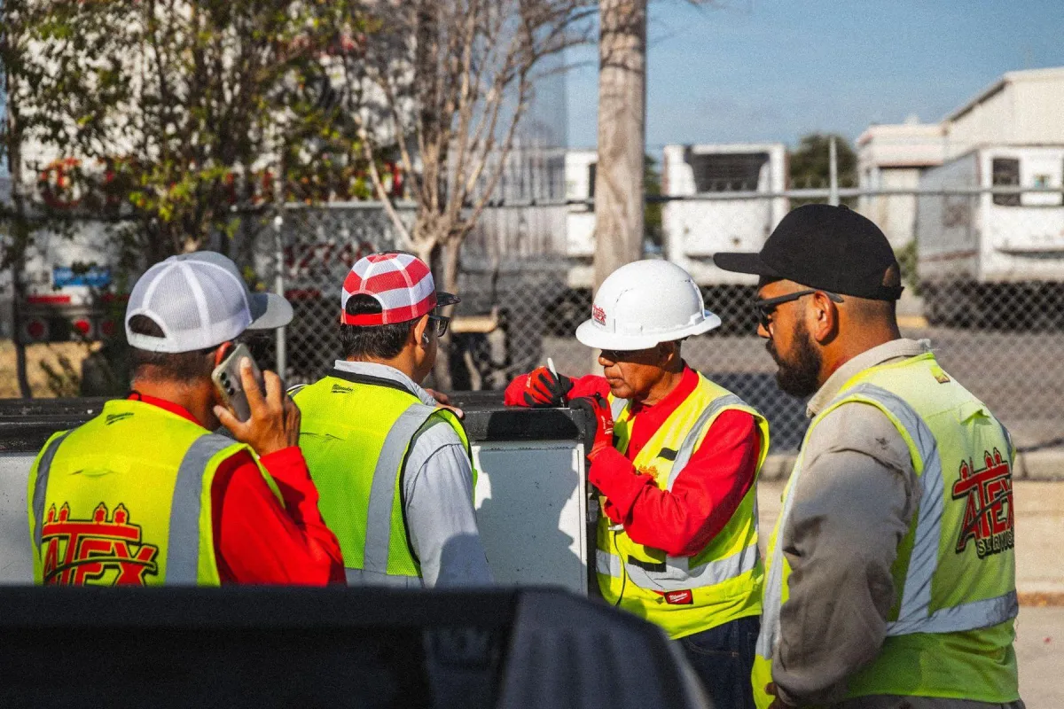 ATEX Services construction crew in safety gear managing on-site architecture and infrastructure projects in Texas and Colorado
