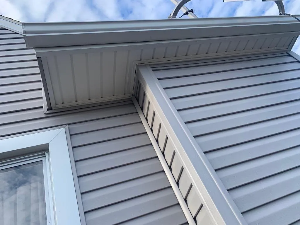 Completed exterior renovation with new siding and trim.