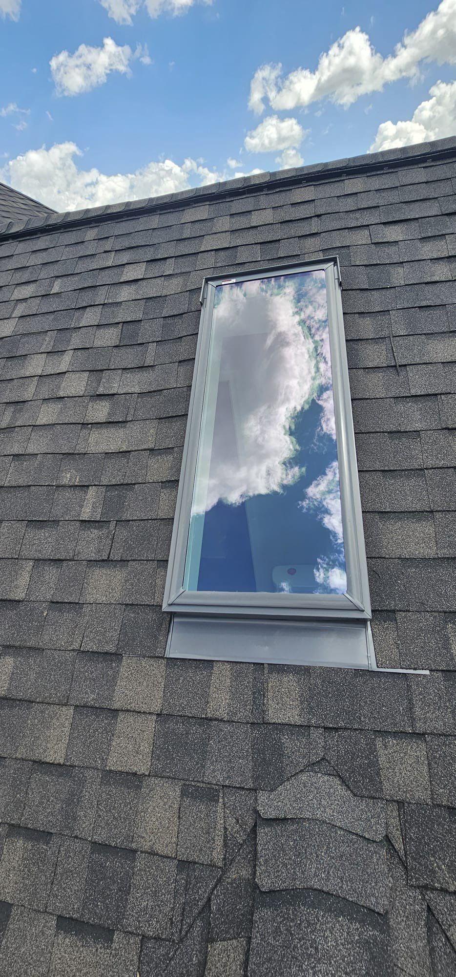 A roof with a newly installed skylight.