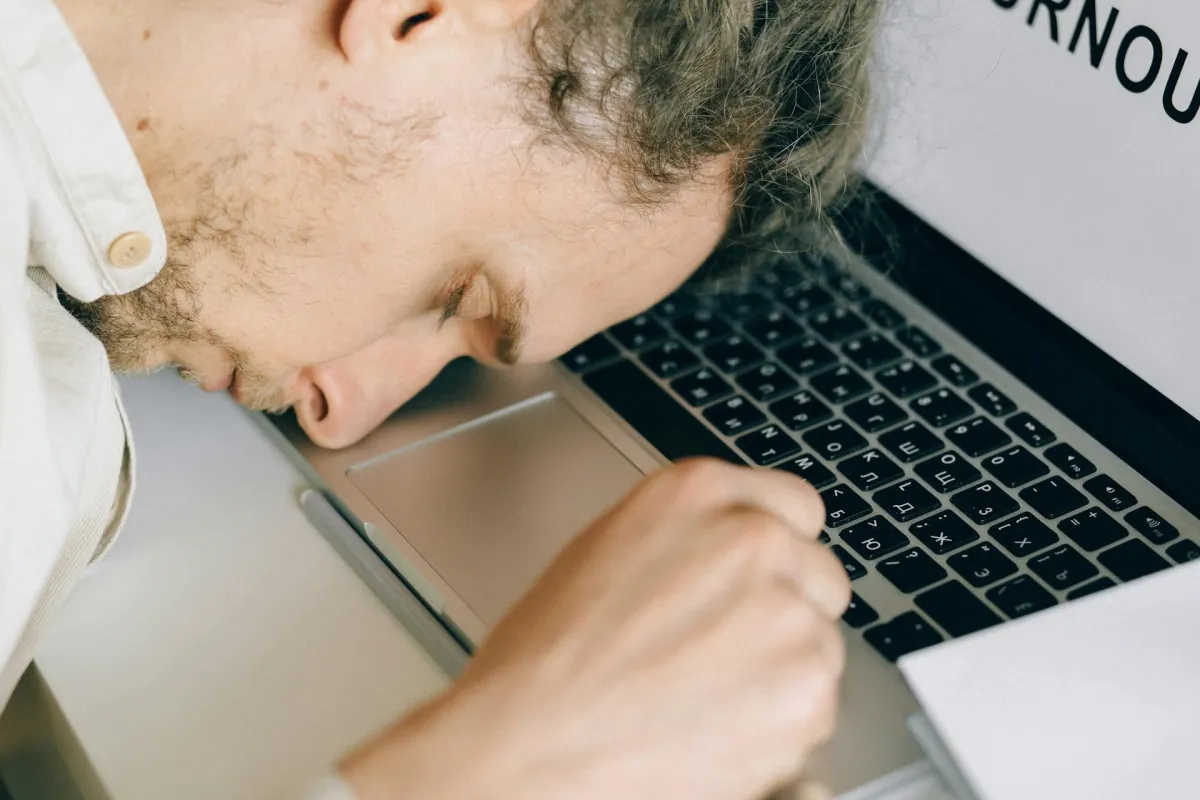 man lying on computer
