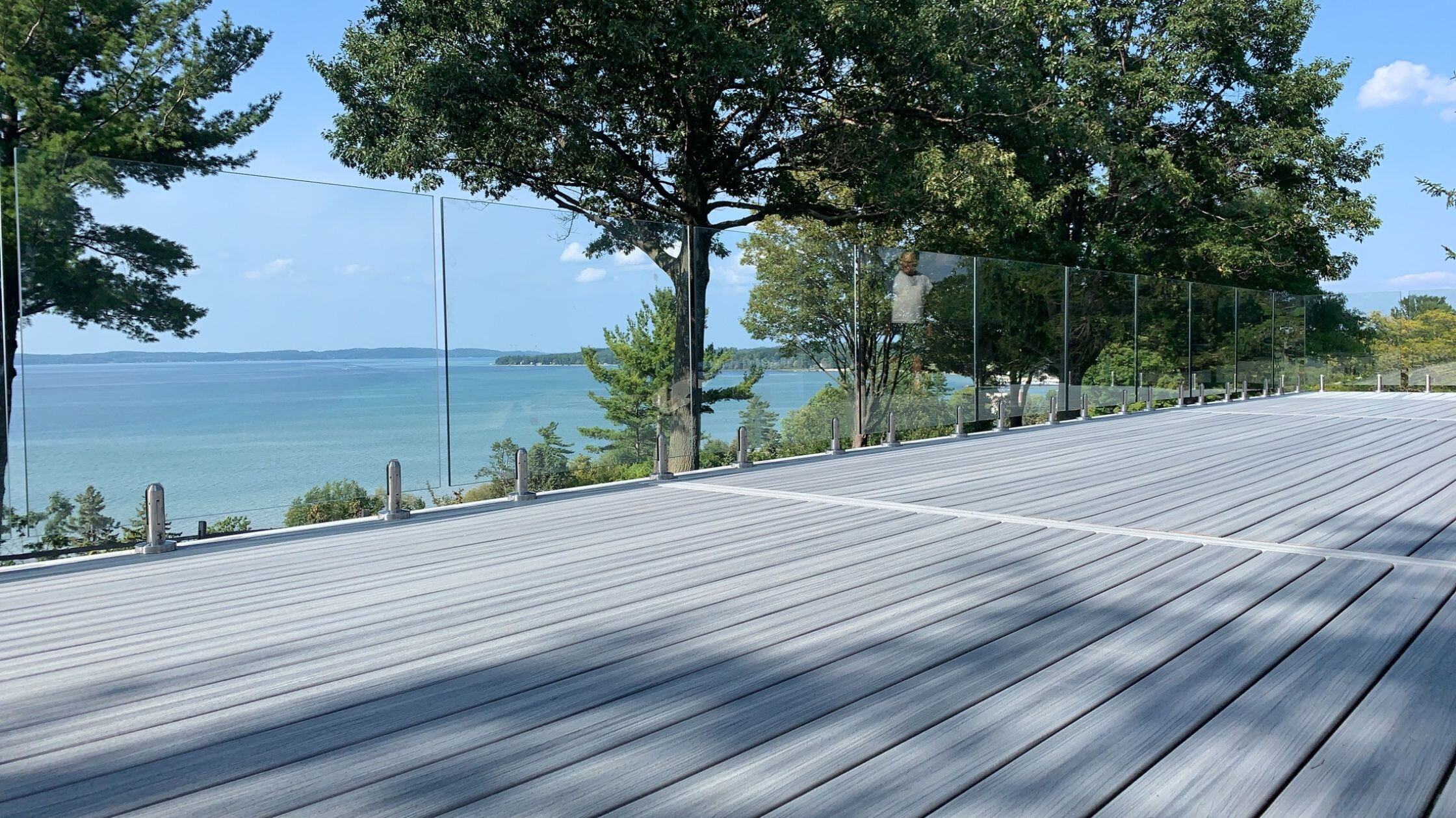 Composite deck with white railing overlooking a lake in Michigan