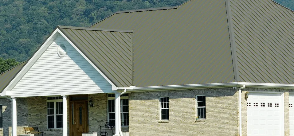 Rustic cabin with new green standing seam metal roof in Fort Collins