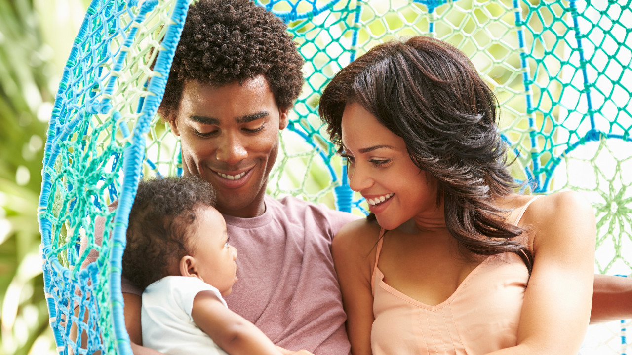 Man and woman holding a toddler.