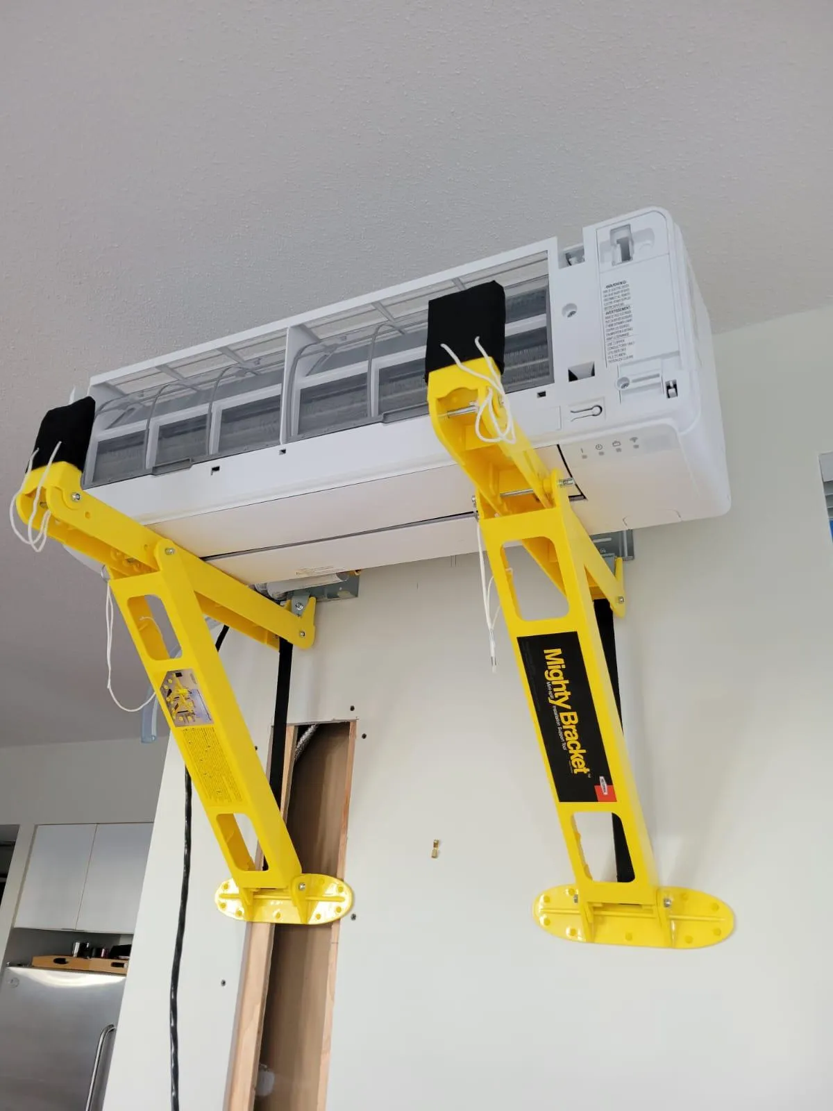 A modern ductless mini-split air conditioner mounted on a living room wall in a British Columbia home, providing quiet and efficient cooling.