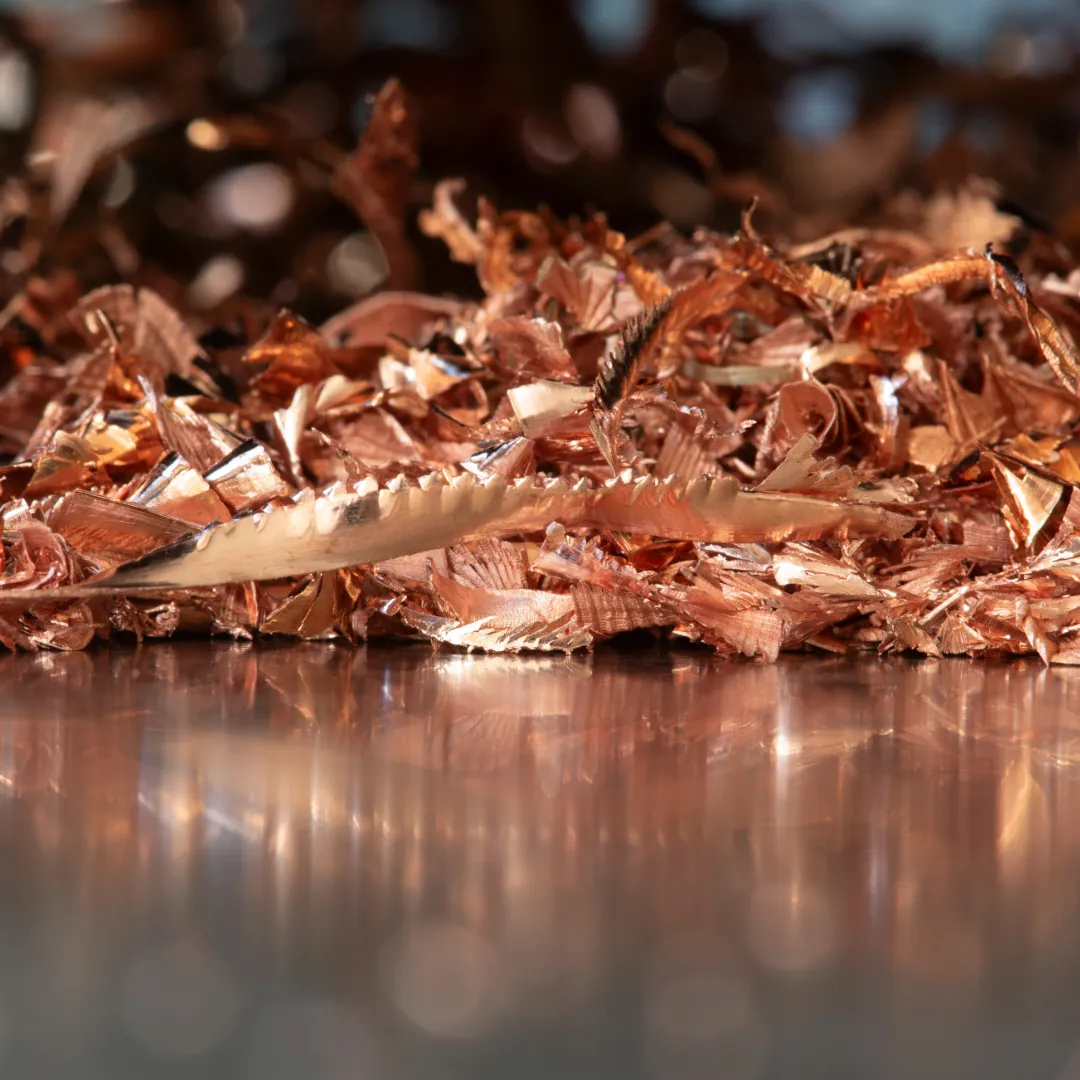 Copper cuttings and shavings on a semi-reflective surface