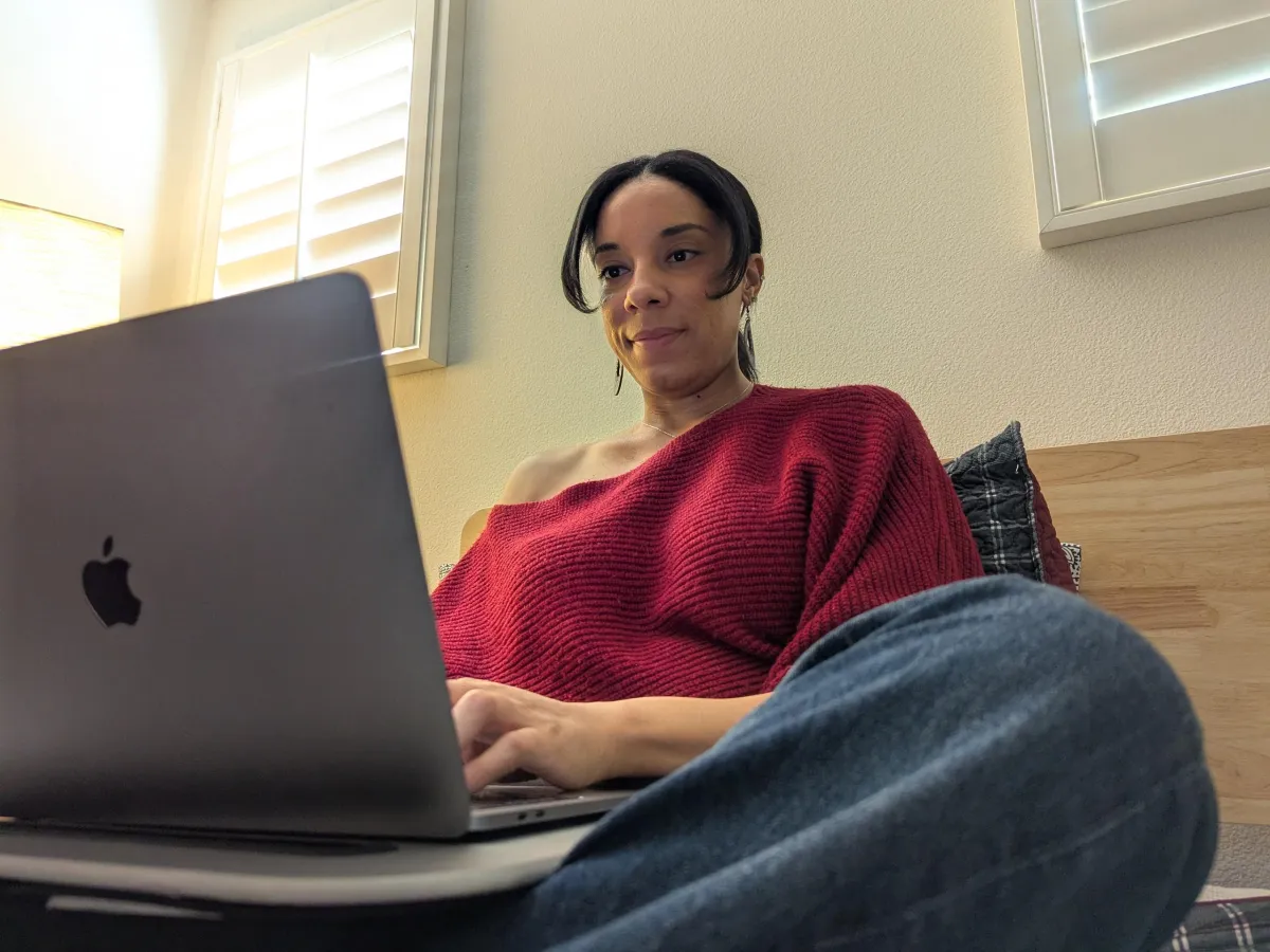 woman wearing red sweater typing