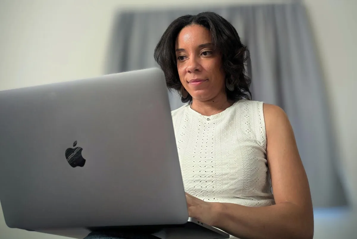 woman wearing white shirt typing on computer
