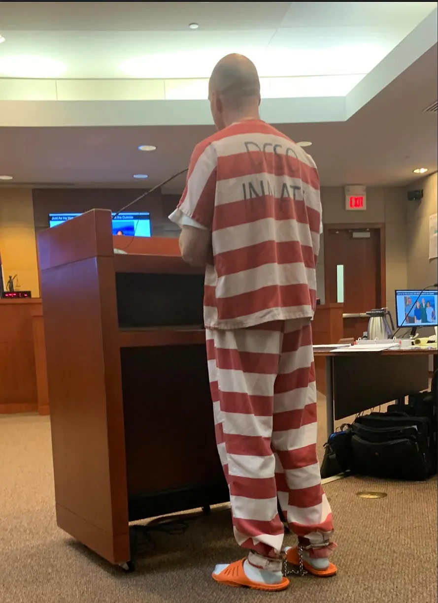 image of inmate standing at podium in court