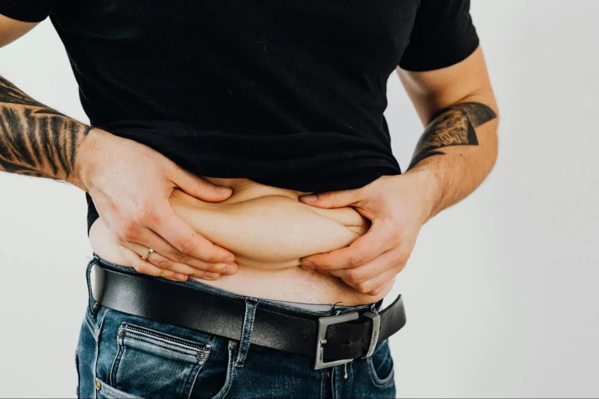 Man Pinching His Belly Fats