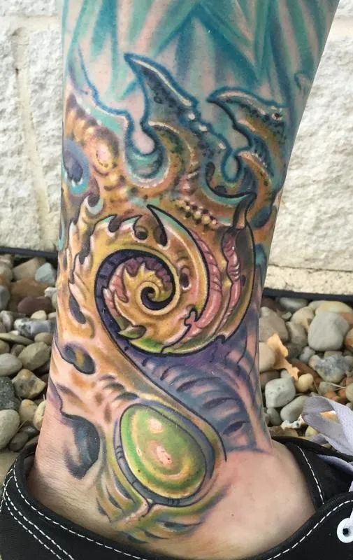 Biomech coil tattoo